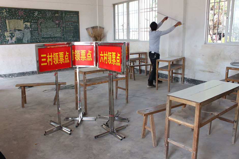 A villager helps prepare for an upcoming vote, January 31, 2012.